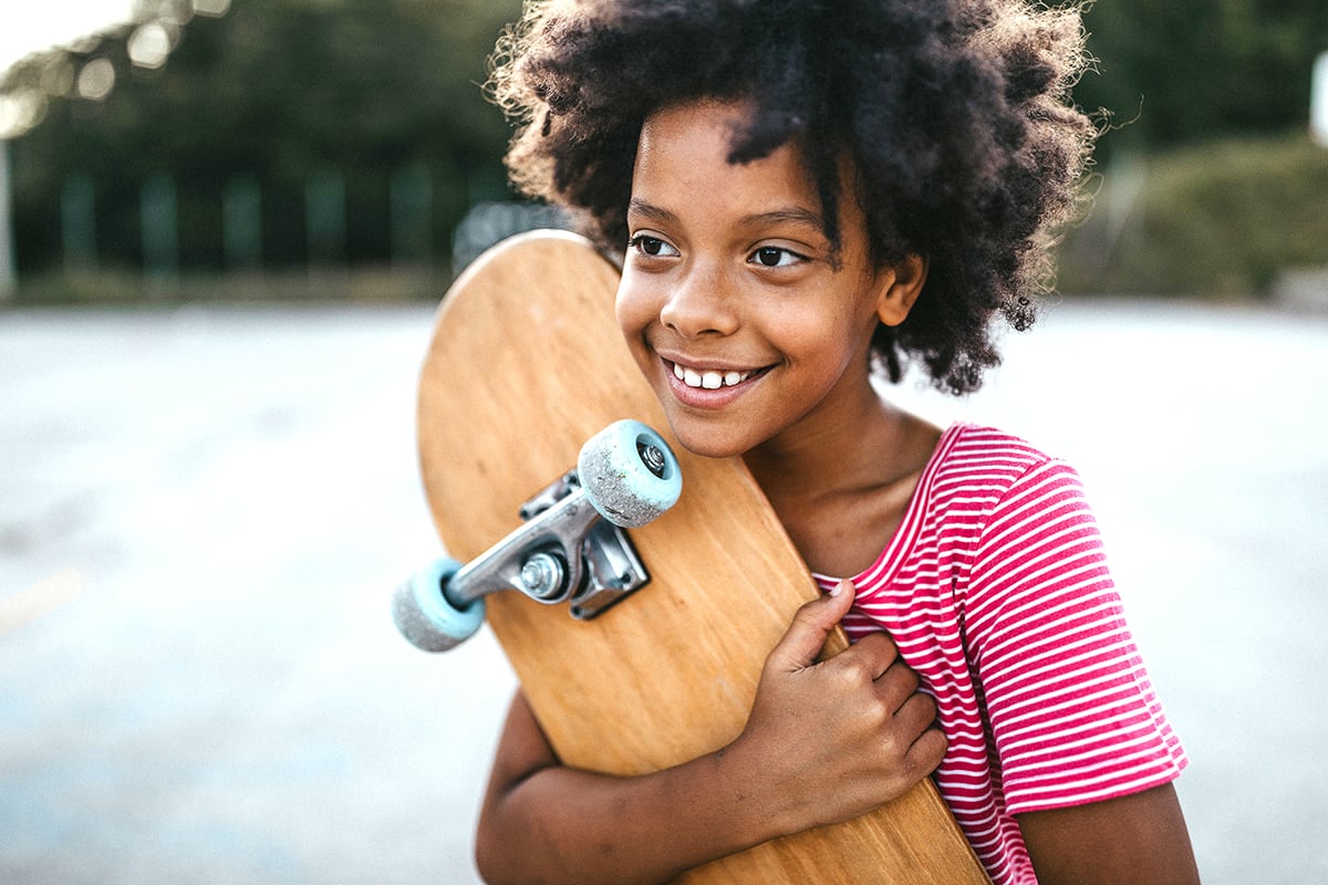 Child hugs a skateboard