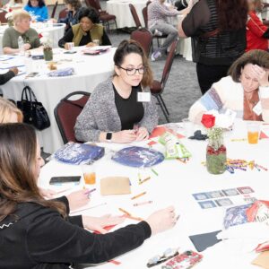 Women color with crayons at CASA Strong Conference