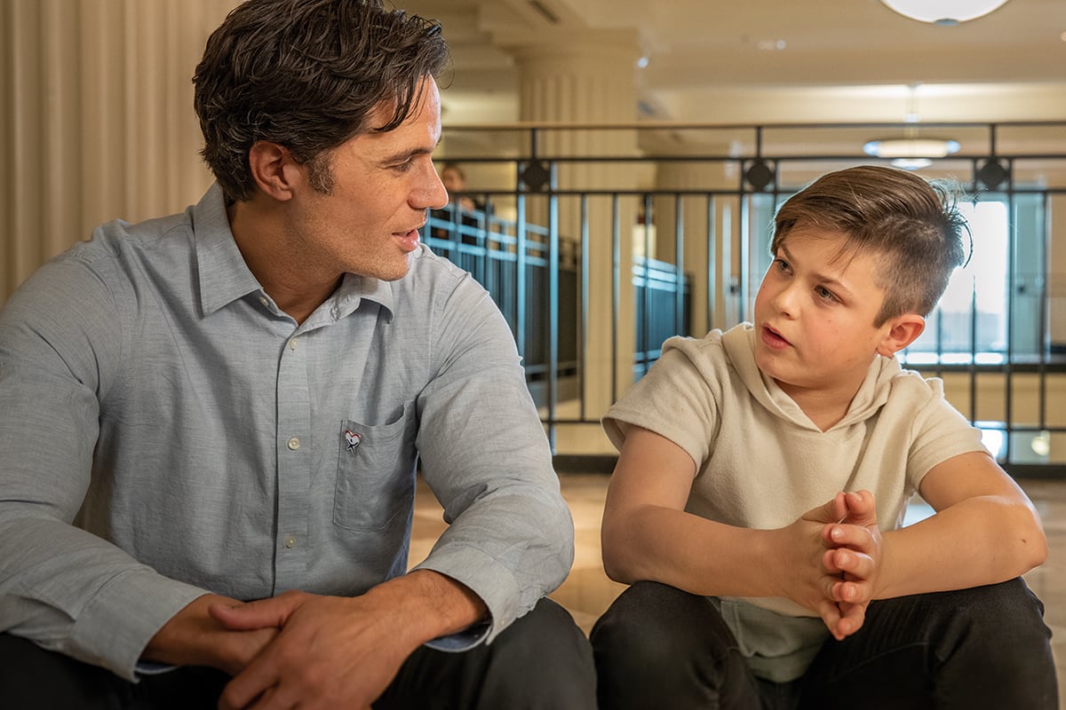 Young kid talking to an adult at a courthouse