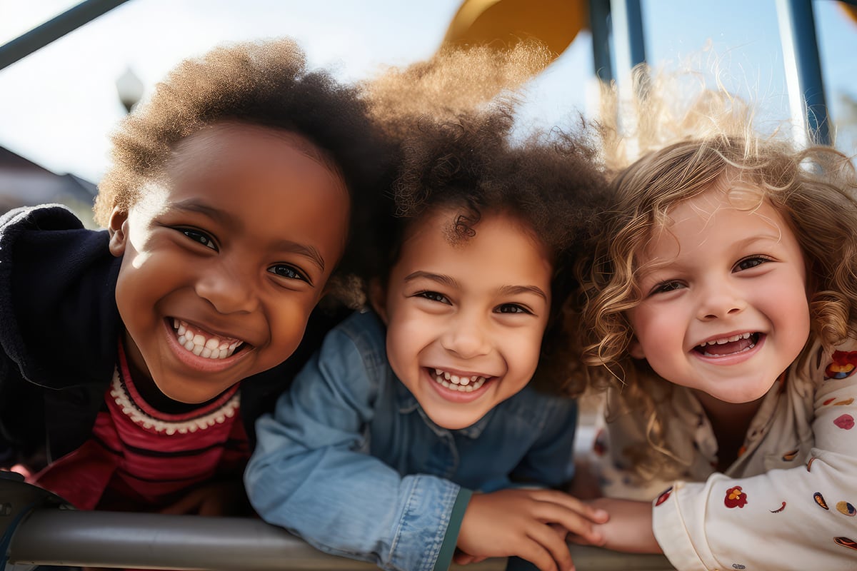 Young children smile together on playground